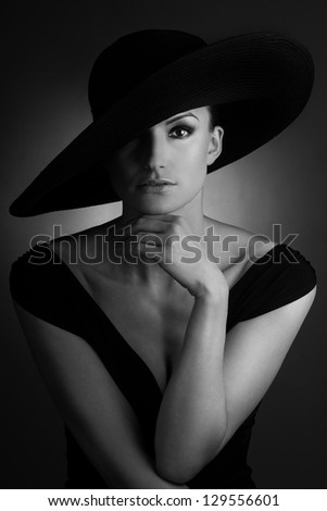 Young beautiful woman with retro big black hat