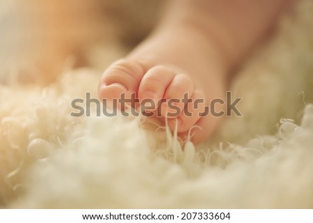 Small delicate little feet of newborn