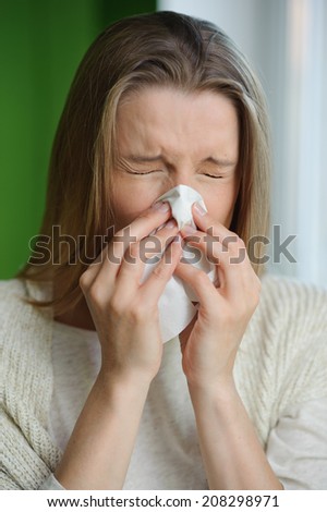 Woman blowing runny nose - Cold flu illness - vertical image