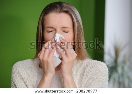 Woman blowing runny nose - Cold flu illness