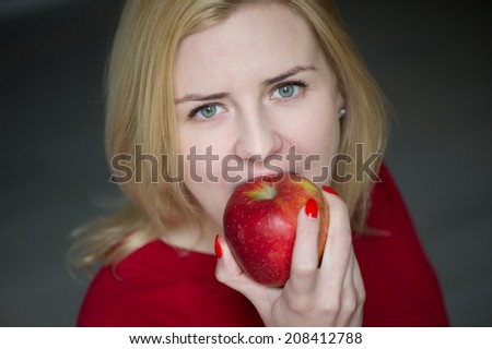 Vetrical - woman eating and biting apple
