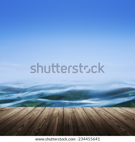Sea background with wooden table, blue water and clear sky