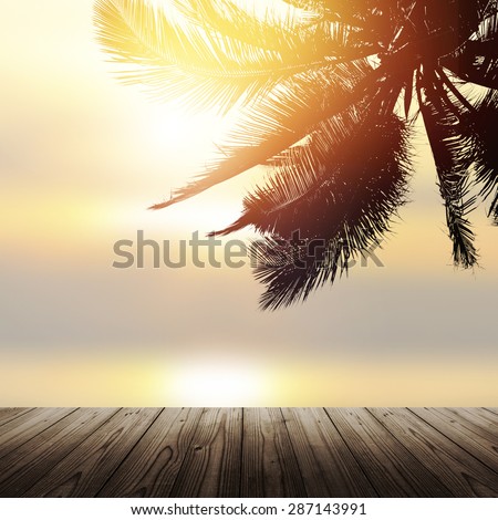 Empty wooden table. Design banner background with coconut palm tree over the ocean at sunrise.