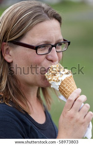 Woman eating ice cream with a happy expression