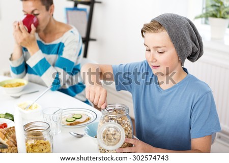 Mother and son having breakfast together in the morning
