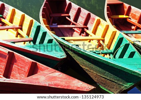 Boats docked side-by-side by the lake