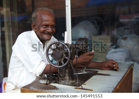 KUMARAKOM, KERALA, INDIA - MAY 1 - A tailor working in Kumarakom, Kerala on May 1, 2013. The town is a popular tourism destination famous for fishing, agriculture and backwaters of the Vembanad Lake.