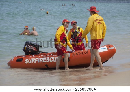 COTTESLOE BEACH, WESTERN AUSTRALIA, 7 DEC 2014: A crew of lifesavers on patrol with a rescue boat.  Founded in 1909, Cottesloe Surf Club is one of the oldest surf lifesaving clubs in Australia.