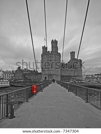 A view across the bridge to Caernarfon Castle, in black and white with red detail