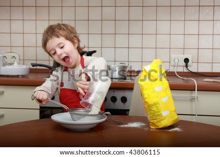 Cooking and singing boy in the kitchen