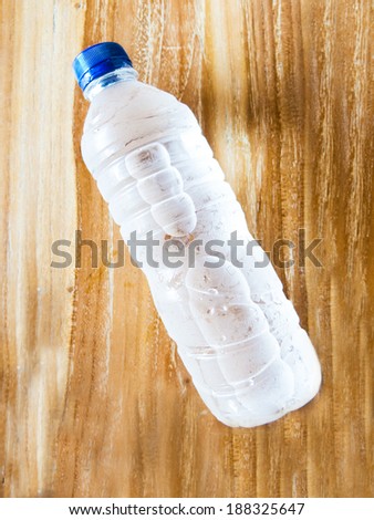 Plastic water bottles on wooden floors.