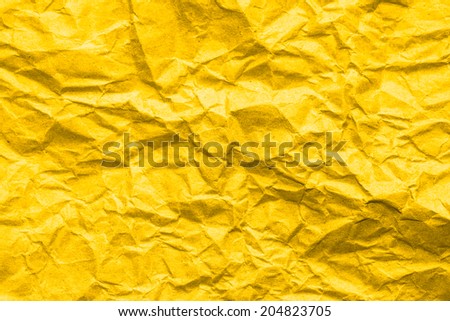 Crumpled golden paper background.