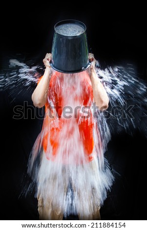 man poured a bucket of ice pour yourself on a black background man poured a bucket of ice pour yourself on a black background