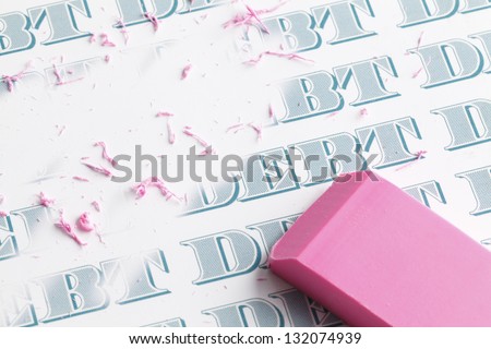Pink eraser erasing multiple debts written in money font.