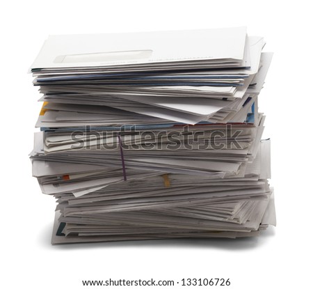 Junk mail stacked high of unpaid bills from the side view, isolated on a white background.