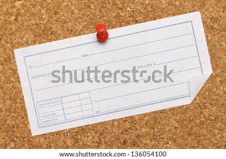 Cork Board with receipt tacked on it.