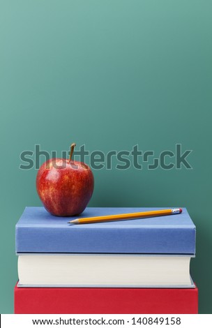 Chalk Board Apple and Books in a Classroom Setting with Copy Space.