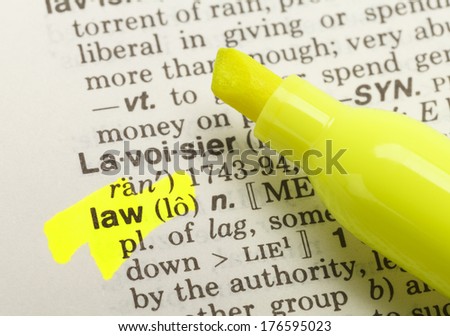The Word Law Highlighted in Dictionary with Yellow Marker Highlighter Pen.