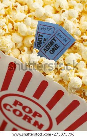 Box of Butter Popcorn with Two Blue Movie Tickets.