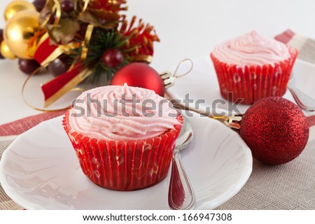 fruitcakes in paper baskets on a New Year\'s table with Christmas tree decorations