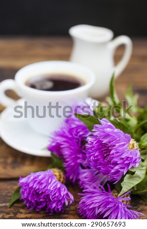 flowers and coffee on a table, selective focus on a flower