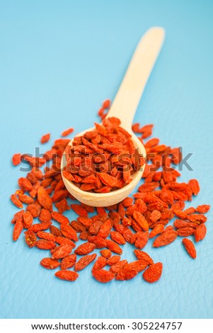 dried berries of a barberry on a blue background, selective focus