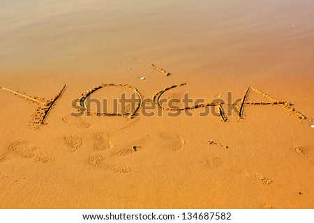 Yoga Word In Sand at Beach