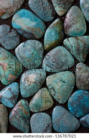 Texture of polished wet turquoise gemstones.