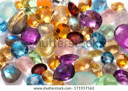 Beautiful gems background. Photo of a sparkling and colorful real gemstones in natural sunlight.