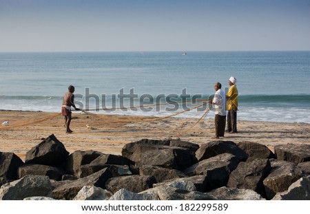 VARKALA, INDIA, DECEMBER 21: Fishermen works at the finishing net on the Odayam Beach on December 21st 2013. Varkala is one of most popular tourist destination in Kerala, South India.