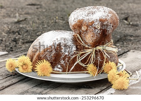 Czech Easter - baked lamb with powdered sugar and dandelions on old wood desk