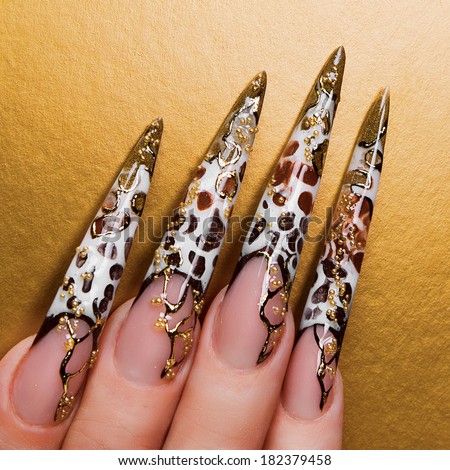Hand with beautiful nails on gold background.