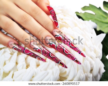 Female hand with red art design nails  .