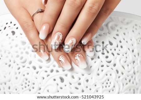 Manicure and white abstract pattern on women\'s nails