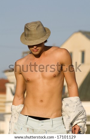 striping young fashion man model with bronzed athletic body