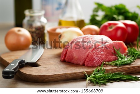 Raw meat and vegetables on wood table background