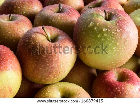 Apples with water drops, food background