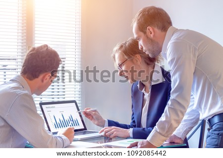 Accounting team discussing financial report data with chart on computer screen in office, consulting people reviewing corporate strategy and business analytics metrics