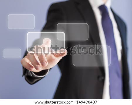 Businessman pointing finger at a touch screen