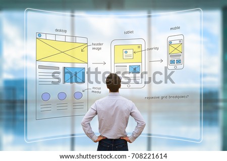 Website development UI/UX front end designer reviewing sketched wireframe layout design mockup for responsive web content with AR screen