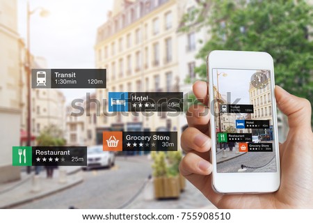 Augmented Reality (AR) information technology about nearby businesses and services on smartphone screen guide customer or tourist in the city, close-up of hand holding mobile phone, blurred street