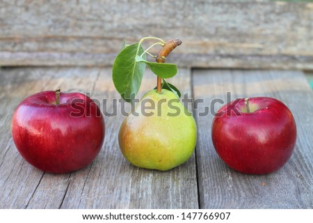 pear and apples on an old table