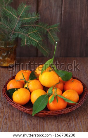 tangerines with leaflets on a brown background