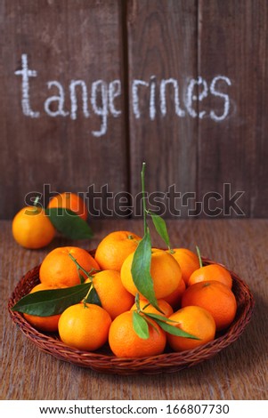 tangerines with leaflets on a brown background