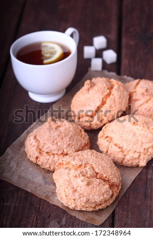 coconut biscuits, tea with sugar and lemon