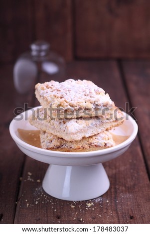 grated cake with jam and powdered sugar