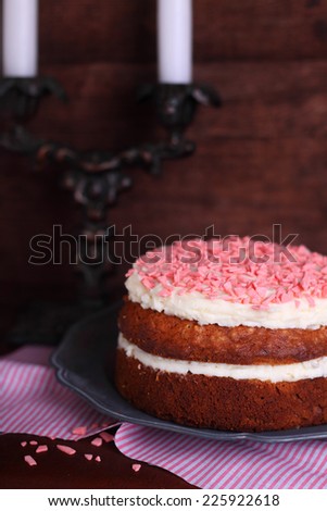 Banana cake with nuts and cream decorated with pink drops
