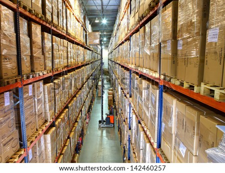 St-Petersburg, Russia - June 13: Storage Of Goods In Large Warehouse Complex, June 13, 2013. High Bay Storage Of Good In Modern Warehouse. Shelves With Boxes Of Stock Large Warehouse, Modern Warehouse