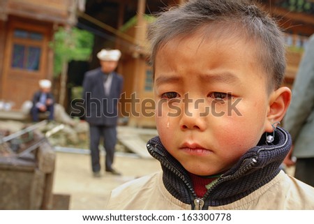 GUIZHOU PROVINCE, CHINA - APRIL 12: Rural areas in south China, boy 8 years of is upset tears on his face, Zengchong Dong ethnic minority Village, Guizhou province, Southwestern China, April 12, 2010