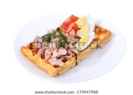 Belgian waffle with ham, boiled egg, tomato slices and dill, isolated image on white background.
